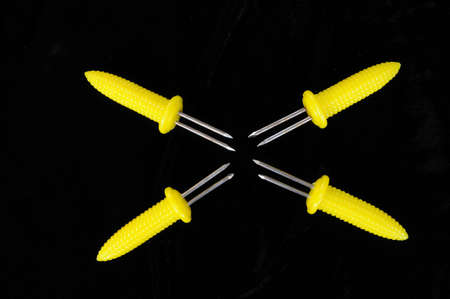 Yellow plastic corn on the cob skewers の写真素材