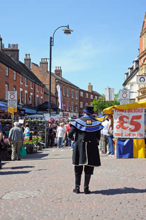 Tamworth, UK - May 17, 2014 - Town Crier standing on the edge of the street market in the centre of town, Tamworth, Staffordshire, England, UK, Western Europe のeditorial素材