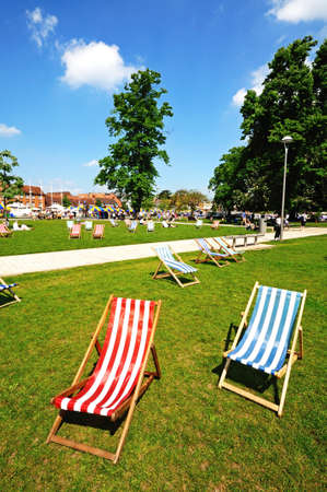 Stratford-upon-Avon, UK - May 18, 2014 - Colourful deckchairs in Bancroft gardens in front of the RSC, Stratford-Upon-Avon, Warwickshire, England, Western Europe のeditorial素材