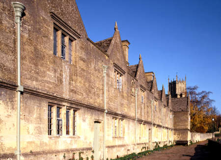 Alms Houses  built in 1612 by Sir Baptist Hicks  with St  James Church tower to rear, Chipping Campden, Gloucestershire, England, UK, Western Europe のeditorial素材