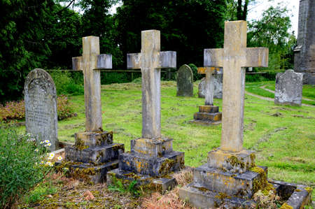 Stone cross tombstones in St Marys church churchyard, Pembridge, Herefordshire, England, UK, Western Europe のeditorial素材
