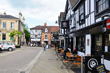 Leominster, United Kingdom - June 5, 2014 - Couple sitting at a table outside a coffee shop in Corn Square with The Merchants House cafe to the rear, Leominster, Herefordshire, England, UK, Western Europe のeditorial素材