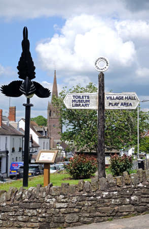 Weobley, United Kingdom - June 5, 2014 - View along Broad Street the magpie sculpture and fingerpost in the foreground and St Peter and St Paul church spire to the rear, Weobley, Herefordshire, England, UK, Western Europe のeditorial素材