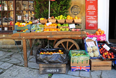 Broadway, United Kingdom - June 12, 2014 - Fruit displayed on an old cart outside a shop along High Street, Broadway, Cotswolds, Worcestershire, England, UK, Western Europe のeditorial素材
