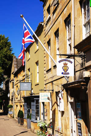Chipping Campden, United Kingdom - June 12, 2014 - Union Jack flag on a flagpole attached the wall of the Royal British Legion building along the High Street, Chipping Campden, The Cotswolds, Gloucestershire, England, UK, Western Europe のeditorial素材