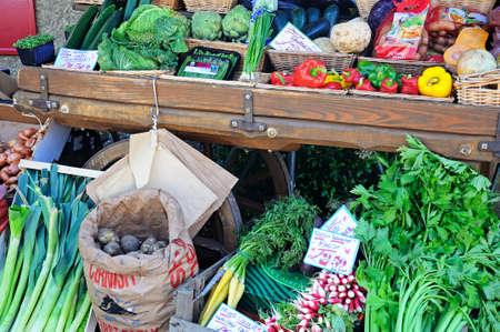 Broadway, United Kingdom - June 12, 2014 - Vegetables displayed on an old cart outside a shop along High Street, Broadway, Cotswolds, Worcestershire, England, UK, Western Europe のeditorial素材