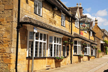 Broadway, United Kingdom - June 12, 2014 - The Horse and Hound Public House along High Street, Broadway, Cotswolds, Worcestershire, England, UK, Western Europe のeditorial素材