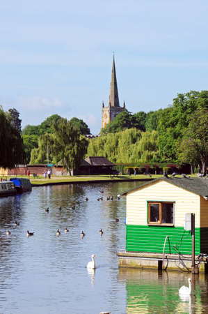 Stratford-upon-Avon, UK - June 12, 2014 - View along the River Avon towards the Holy Trinity Church,...