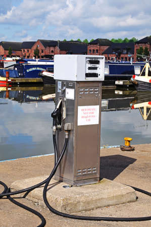 BARTON-UNDER-NEEDWOOD, UK - MAY 21, 2014 - Red Diesel dispenser with narrowboats to the rear in the canal basin, Barton Marina, Barton-under-Needwood, Staffordshire, England, UK, Western Europe のeditorial素材