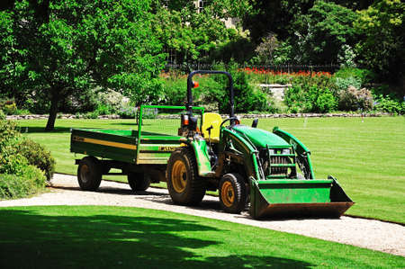 Oxford, United Kingdom - June 17, 2014 - Green utility tractor with front mounted bucket, Oxford,...