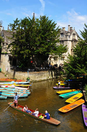 Oxford, UK - June 17, 2014 - Punts and rowing boats on river Cherwell with Magdalen college to the...
