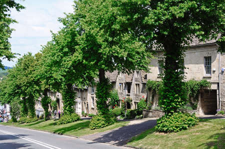 Burford, UK - June 17, 2014 - Cotswold cottages along the hill leading to the shops along the High Street, Burford, Oxfordshire, England, UK, Western Europe のeditorial素材