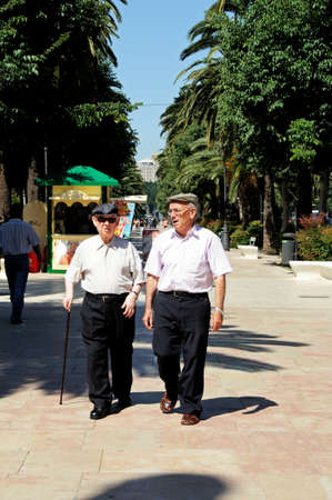 Malaga, Spain - June 14, 2011 - Elderly Spanish men walking along the Paseo del Parque, Malaga, Costa del Sol, Malaga Province, Andalucia, Spain, Western Europe のeditorial素材