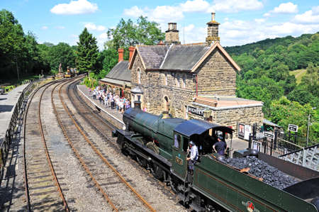 Highley, UK - July 10, 2014 - Steam Locomotive 7800 Class 4-6-0 Erlestoke Manor number 7812 in Great Western Railways green with the late British Rail Crest approaching the railway station platform, Highley, Worcestershire, England, UK, Western Europe のeditorial素材