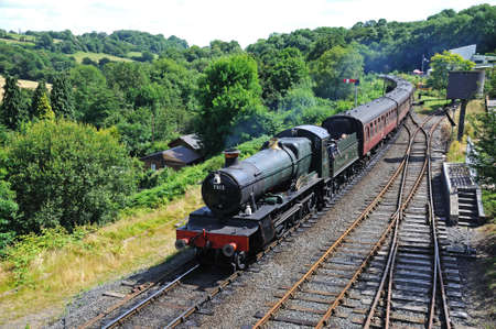 Highley, UK - July 10, 2014 - Engine driver preparing for the token exchange on the footplate of Steam Locomotive 7800 Class 4-6-0 Erlestoke Manor number 7812 in Great Western Railways green, Highley, Worcestershire, England, UK, Western Europe のeditorial素材