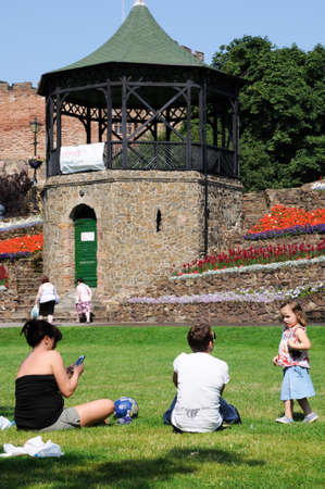 Tamworth, United Kingdom - July 23, 2014 - View of the castle gardens and bandstand with the Norman castle to the rear with people sitting on the grass enjoying the sunshine, Tamworth, Staffordshire, England, UK, Western Europe.のeditorial素材