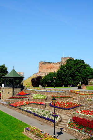 Tamworth, UK - July 23, 2014 - View of the castle gardens and bandstand with the Norman castle to...