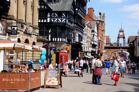 Chester, UK - July 22, 2014- Pavement cafe along Eastgate with view towards the Eastgate Clock at...