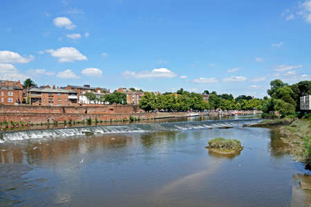 Chester, UK - July 22, 2014 - View of the weir along the River Dee with buildings to the rear, Chester, Cheshire, England, UK, Western Europe.のeditorial素材