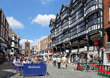 Chester, UK - July 22, 2014 - Buildings and shops along Bridge Street with St Peters church to the rear and a pavement cafe in the foreground, Chester, Cheshire, England, UK, Western Europe.のeditorial素材