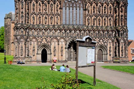 Lichfield, UK - May 3, 2014 - Cathedral West front with group of people sitting on the lawn in the foreground, Lichfield, Staffordshire, England, United Kingdom, Western Europe.のeditorial素材
