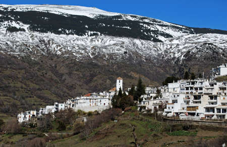 General view of village and snow capped mountains, Capileira, Las Alpujarras, Granada Province, Andalucia, Spainの写真素材