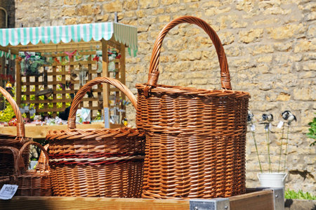Bourton on the Water, UK - June 12, 2014 - Wicker baskets for sale outside a shop in the village centre, Bourton on the Water, Gloucestershire, England, UK, Western Europe.のeditorial素材