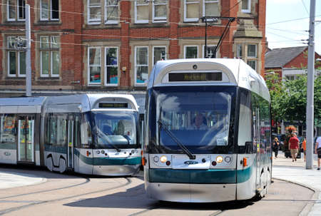 Nottingham, UK - July 17, 2014 - Modern trams travelling round the Old Market Square, Nottingham, Nottinghamshire, England, UK, Western Europe.のeditorial素材
