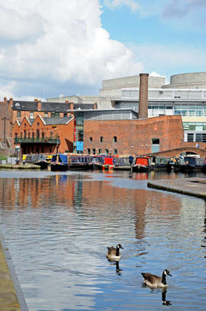 Birmingham, UK - May 14, 2014 - Narrowboats in Gas Street Canal Basin with Canada Geese in the foreground, Birmingham, West Midlands, England, UK, Western Europe.のeditorial素材