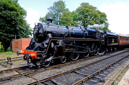 Arley, UK - July 10, 2014 - Steam Locomotive British Rail Standard Class 5 4-6-0 number 73129 in British Rail Black leaving the railway station, Severn Valley Railway, Arley, Worcestershire, England, UK, Western Europe.のeditorial素材