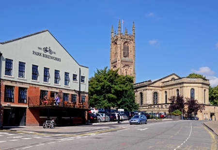 Derby, UK - July 17, 2014 - The Cathedral of All Saints with a bike shop and cafe to the left hand side, Derby, Derbyshire, England, UK, Western Europe.のeditorial素材