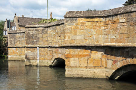 Medieval stone bridge over the river Windrush, Burford, Oxfordshire, England, UK, Western Europe.の写真素材