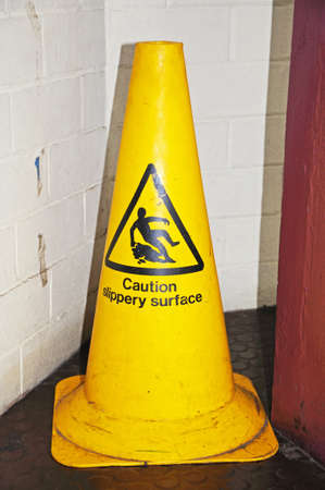 Yellow Caution Slippery Surface coneの写真素材