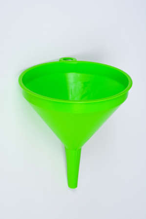 Green plastic funnels against a plain background.の写真素材