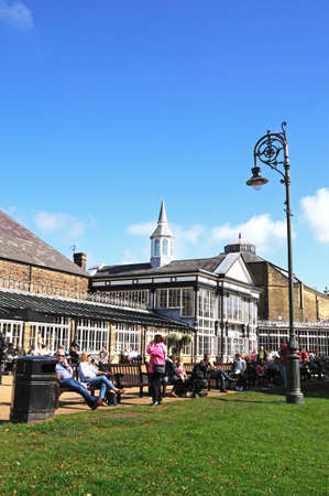 Buxton, UK - September 7, 2014 - People sitting on benches in the Pavilion Gardens, Buxton, Derbyshire, England, UK, Western Europe.のeditorial素材