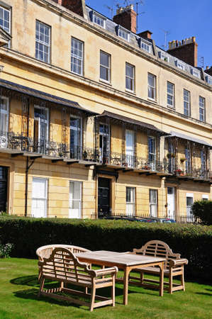 Wooden table and chairs outside the Royal Mews Georgian houses in Suffolk Square, Cheltenham, Gloucestershire, England, UK, Western Europe.のeditorial素材