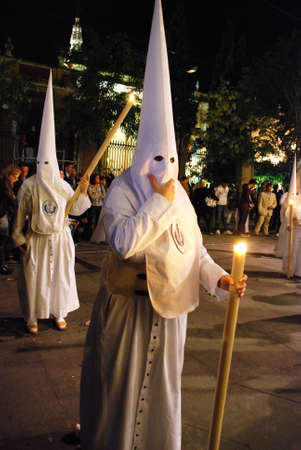 Seville, Spain - April 7, 2009 - Members of the Candelaria brotherhood at night during Santa Semama, Seville, Seville Province, Andalusia, Spain, Western Europe.のeditorial素材