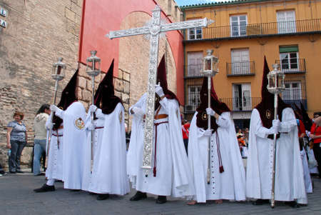 Seville, Spain - April 7, 2009 - Members of El Cerro brotherhood walking through the city streets...