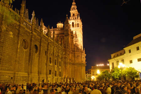 Seville, Spain - April 7, 2009 - Member of La Bofeta brotherhood walking through the crowds around the Cathedral at night during Santa Semama, Seville, Seville Province, Andalusia, Spain, Western Europe.のeditorial素材