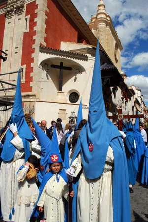 Seville, Spain - April 7, 2009 - Members of the San Esteban brotherhood walking through the city centre streets during Santa Semana, Seville, Seville Province, Andalusia, Spain, Western Europe.のeditorial素材