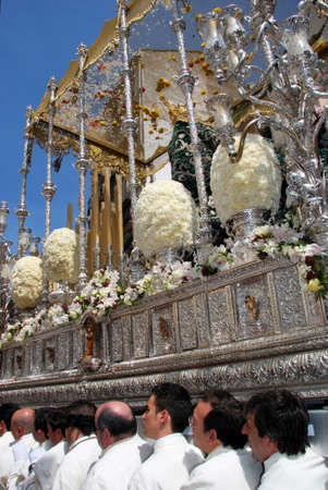 Malaga, Spain - April 5, 2009 - Members of the Pollinca brotherhood carrying the float through the...