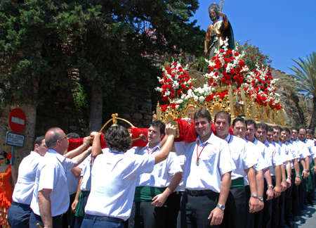 Bearers carrying a Statue of Saint Bernard on a float through the town streets during the Romeria San Bernabe, Marbella, Costa del Sol, Malaga Province, Andalusia, Spain, Western Europe.のeditorial素材