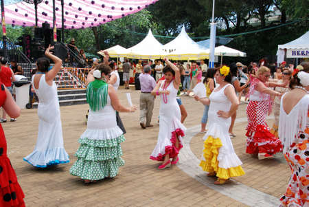 Spanish women flamenco dancing during the Romeria San Bernabe festival, Marbella, Costa del Sol, Malaga Province, Andalusia, Spain, Western Europe.のeditorial素材