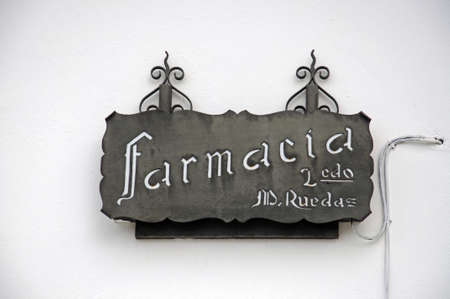 Rustic metal pharmacy sign on a wall, Casares, Cadiz Province, Costa del Sol, Malaga Province, Andalusia, Spain, Western Europe.のeditorial素材