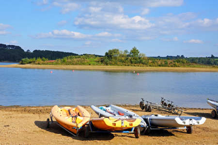 View across Carsington Reservoir with small boats on the shoreline, Derbyshire, England, UK, Western Europe.のeditorial素材