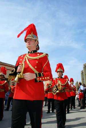 Members of the Huerto brotherhood brass band walking through the city centre streets during Santa...