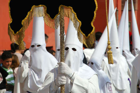 Members of the Salutation brotherhood walking through the city streets during Santa Semana week,...