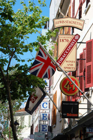 Shop signs and British flag on buildings along Main Street, Gibraltar, United Kingdom, Western Europe.のeditorial素材
