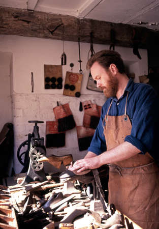 Victorian cobbler making shoes in a workshop at the Black Country Living Museum, Dudley, West Midlands, England, UK, Western Europe.のeditorial素材