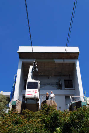 Cable car in the cable car station with a couple looking over the fence, Gibraltar, United Kingdom,...